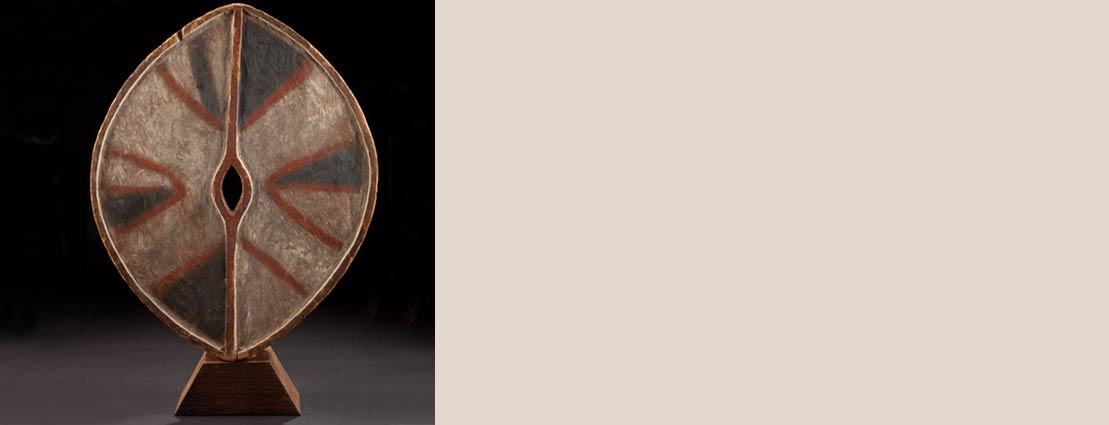 A KENYAN PAINTED WOOD DANCE SHIELD Kikuyu, early 20th century A KENYAN PAINTED WOOD DANCE SHIELD Kikuyu, early 20th century